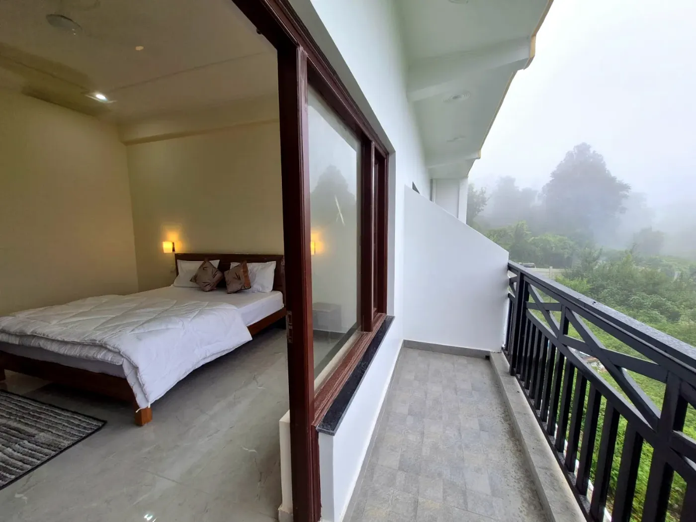Bedroom opening to a valley-view balcony